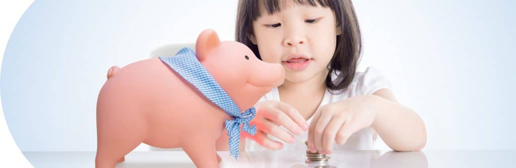 Money - Girl with coins and Rubber Piggy Bank