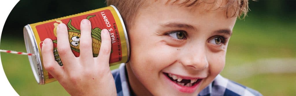 Tin Toys Category - Boy listening to Tin Can Telephone