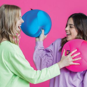 Lifestyle shot of two women playing with a blue and pink Nee Doh Dohzee