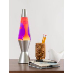 14.5” LAVA® Lamp – Yellow/Purple/Silver on a table with a notebook and tiki mug pencil cup