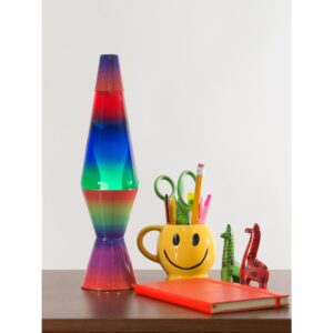 14.5” LAVA® Lamp Colormax Rainbow – White/Tricolor on a table with a smiley face pencil cup, notebook, and giraffe figurines