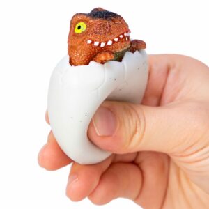 Squeezy Egg Popper toy in hand, squeezed and brown dino popping out