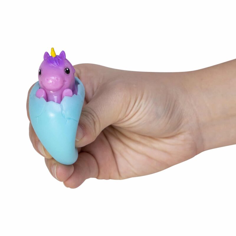 Squeezy Egg Popper toy in hand, squeezed and purple unicorn popping out