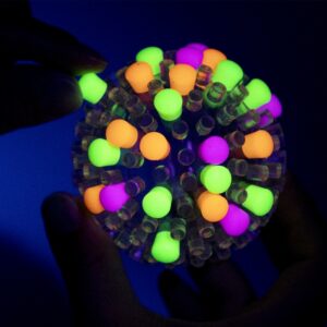 Brite Ball glow in the dark caps being placed on Brite Ball in the dark