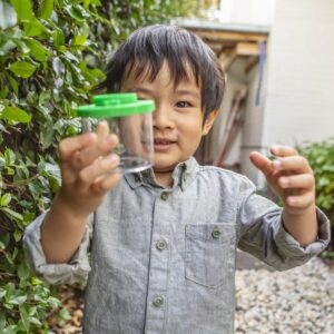 Tiger Tribe Bug Spotter Kit - Lifestyle shot with boy holding magnifying Bug Spotter