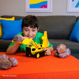 Tonka Trencher - Boy in Living Room lifting play rocks