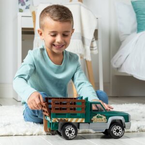 Boy playing with the Tonka Farm Truck on a bedroom floor