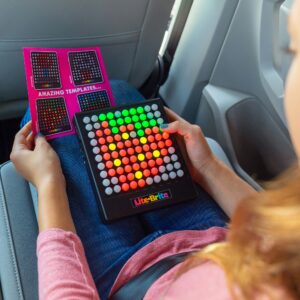Lite Brite Touch Lifestyle Shot with girl creating a design based on the included templates