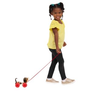 Lifestyle shot of girl pulling the Fisher-Price Little Snoopy