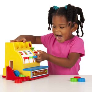 Lifestyle shot of girl playing with the Fisher-Price Cash Register