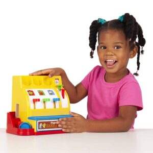Lifestyle shot of girl closing the money door on the Fisher-Price Cash Register