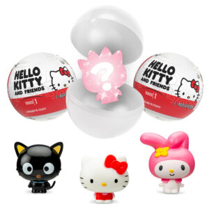 A collection of "Hello Kitty and Friends" surprise toys. Front and center are three figurines: Chococat (black cat), Hello Kitty (white cat with red bow), and My Melody (pink bunny). Above them are two partially opened capsule containers showcasing the mystery aspect.