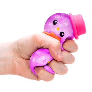 A hand is squeezing a NeeDoh Groovy the Glowman on a white background. The toy is squishing through the fingers of the hand, showing its soft, squeezy nature.