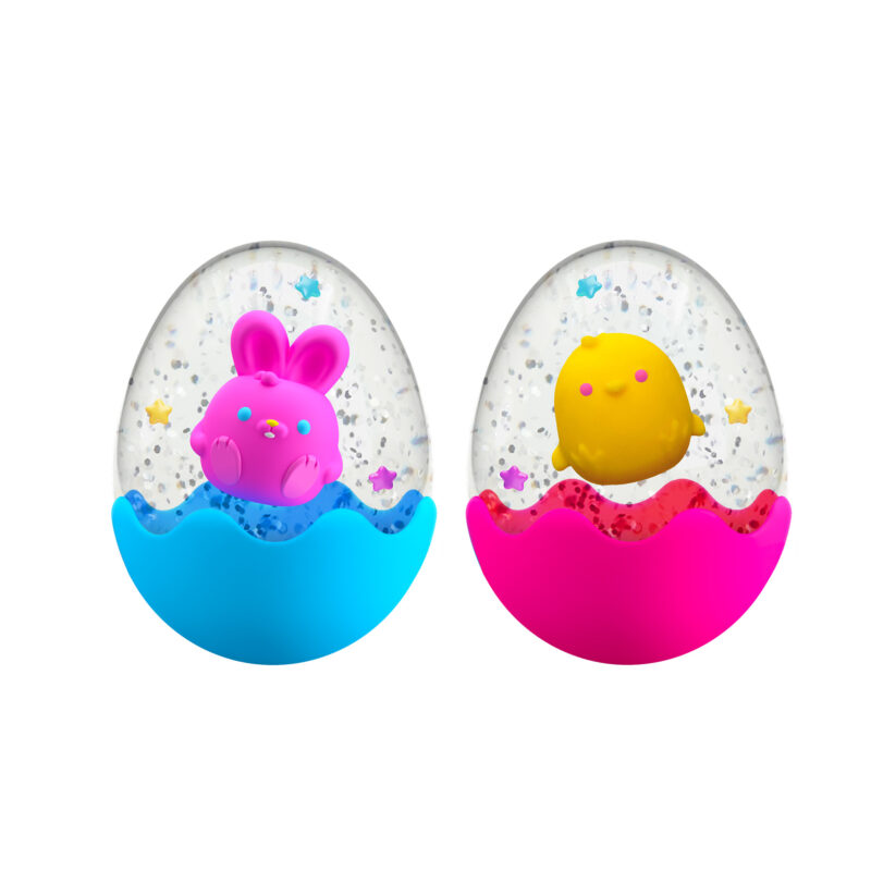 Two colorful toys inside transparent eggs with water and glitter. The left egg, with a blue base, contains a purple bunny; the right egg, with a pink base, holds a yellow chick. Both eggs contain floating stars and shiny particles.