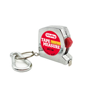 A small, silver tape measure with a carabiner attachment. The tape measure has a red and yellow label that reads "Schylling TAPE MEASURE, 3FT/1M." A metal carabiner is attached to the chain loop.