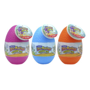 Three Mystery Eggs sit side by side. A magenta egg is on the left, a blue egg is in the middle, and an orange egg is on the right. The eggs are solid colors and are wrapped with a label showing the product name.